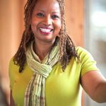 Pastor Brenda Salter McNeil, a Black woman, smiles at the camera